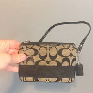 Black and cream coach wristlet.